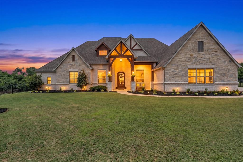 MOTIVATED SELLERS! PRICE REDUCTION! Luxury, privacy, and rare Corps of Engineers adjacent property defines this exceptional Waters Edge estate. Positioned on an oversized acre lot with a protected wooded backdrop, this home delivers true, long-term seclusion in one of the area’s most desirable lake-adjacent communities.

Inside, soaring 12-foot ceilings, rich hardwood floors, and walls of oversized windows create an immediate sense of scale and light. The one story, open-concept design seamlessly connects the main living spaces for both entertaining and everyday comfort.

The chef’s kitchen is built to perform and impress — featuring a massive island, double ovens, commercial-grade gas range, stand alone refrigerator freezer appliances, custom cabinetry, walk-in pantry, and premium finishes throughout.

This home offers 5 bedrooms plus a media room, providing flexibility for guests, work, or additional living space. The primary suite is a true retreat with a spa-inspired bath, oversized shower and soaking tub, and a custom walk-in closet. French doors connect the primary suite to the backyard patio for added convenience.

Step outside to a covered 800 sq ft patio providing ample entertaining and dining spaces shaded for everyday use and comfort. Whether entertaining or unwinding, the backyard feels like an escape.

Complete with a 4-car extra deep garage with Tesla charger, resort-style community pool, and private lake access, this home combines luxury finishes, functional space, and one of the strongest privacy settings in Waters Edge.