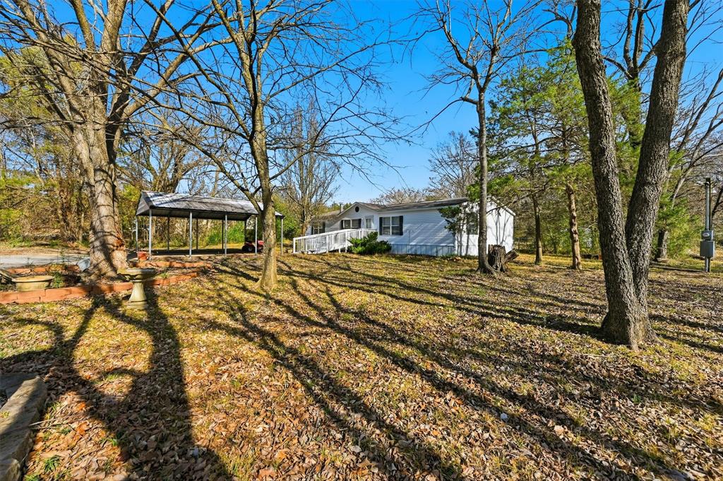 LOCATED at the end of a private road with only two neighbors.  Are you looking to get out of town but still be close to all stores and shopping?  Located on a beautiful  1.165 acre lot.   Home features trees and wooded area in backyard to bird watch and the varied wildlife that stops by is such an pleasure to see.  The backyard work shop is a delight to the man in your to putter around in.   Nice big living area with fireplace.   Large open kitchen with island.   Lots of windows to look at the property. This four-bedroom home has space for you and your family.  You can have a garden or just enjoy the various birds and wildlife.  Located about 5 to 7 minutes from downtown Denison. Workshop in back yard is approx.  20x10.   You can set up a workshop or just have extra storage space.   Located out of the city hustle and bustle yet close to shopping.  City of Denison water and sewer. Home purchased originally through FHA loan.