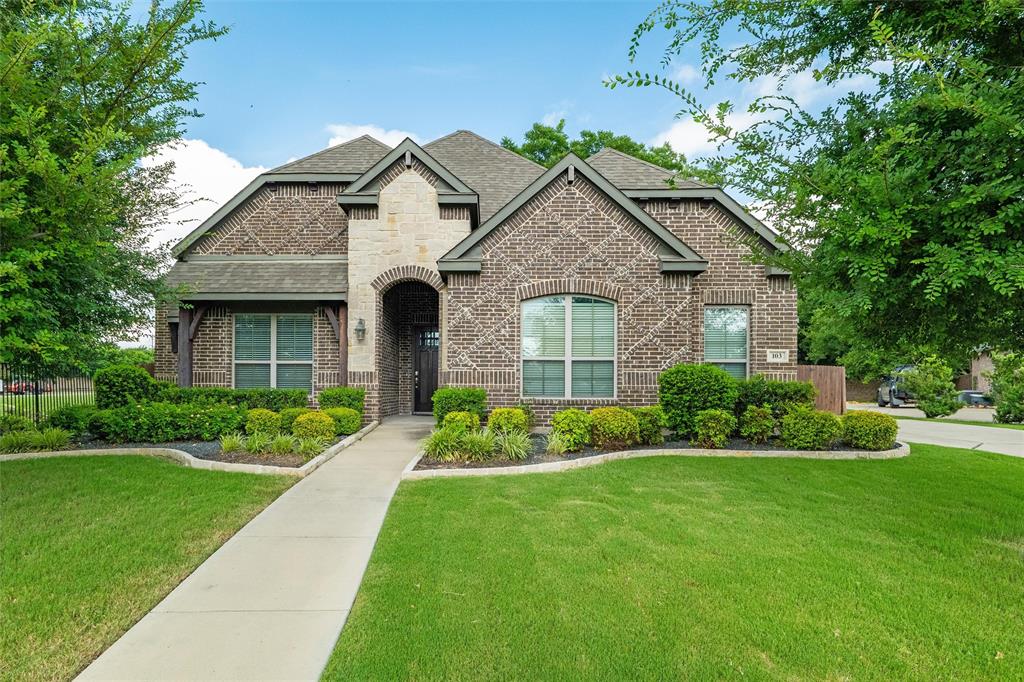 Nestled in the heart of one of Waxahachie’s most sought-after neighborhoods, 103 Water Garden Drive is where space, style, and functionality meet. This expansive 5-bedroom, 3-bath home sits on a beautifully manicured corner lot and features two spacious living areas, a dedicated office, and a versatile game room—perfect for both everyday living and entertaining.

The open-concept kitchen shines with granite countertops, stainless steel appliances, and custom cabinetry, while the main living room impresses with hardwood floors, a cozy fireplace, and abundant natural light. The primary suite offers a peaceful retreat with high ceilings and a spa-inspired ensuite bath.

Upstairs, the flexible loft space and generously sized bedrooms provide room for everyone to spread out. A lush backyard shaded by mature trees offers privacy and room to play or relax.

Thoughtfully designed and move-in ready, this home blends timeless charm with modern comfort—all just minutes from schools, shopping, and dining.