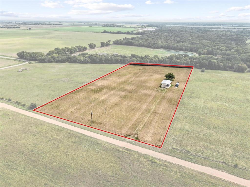 Are you looking for a quiet, country spot to build your dream house? This property has started the work for you!
5.2+ acres complete with water meter already installed electric on the property! Thousands of dollars in savings for you there already. Planning to stay in the camper while you build on-site? There's a 30X40 metal carport with concrete pad to park it under with a 50 amp hookup! The work shed with hookup conveys with the property. This tract of land runs in between two county roads, so two access points are possible. 
Approximately 10-15 minutes from Bois d'Arc Lake, the possibilities are endless for this property! Come take a tour today.