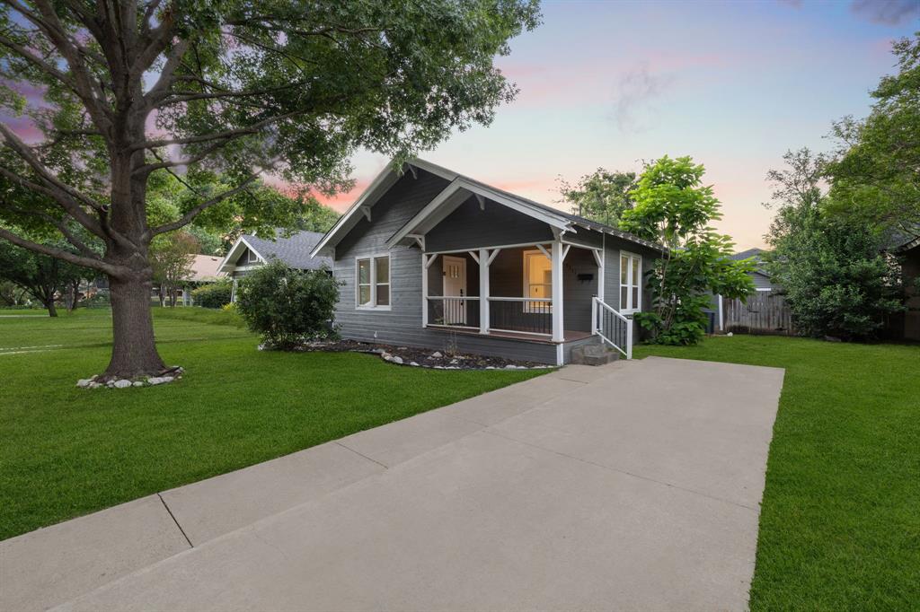 In the heart of coveted Vickery Place, 5311 Willis Ave blends timeless Craftsman character with fresh, thoughtful updates just steps from the dining and nightlife of Lower Greenville and Henderson. A classic front porch beneath mature shade trees welcomes you to this 3-bedroom, 2-bath bungalow with a 1-car garage. Inside, natural light pours through walls of windows onto hardwood-style flooring, accenting an airy living and dining area anchored by the original mantle. The bright kitchen features navy shaker cabinetry, granite countertops, a crisp tile backsplash, stainless steel appliances, and a window-wrapped breakfast nook. A split-bedroom layout maximizes privacy, while both baths are finished with ceramic tile and modern fixtures for a clean, polished look. Out back, the oversized yard is built for entertaining with an expansive deck and built-in bench—plus your own putting green for year-round fun. Currently a successful short-term rental, this home offers a turnkey investment option or an equally appealing move-in ready residence—rich with charm and walkable to favorite restaurants, bars, and cafes.