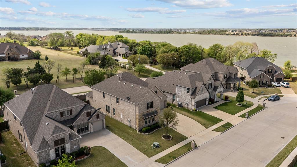 Located in the sought after Vineyards community with easy access to Lake Ray Hubbard, Lakeside Park, & Paddle Point Park, this beautifully designed PRE-INSPECTED 4 bedroom, 4.5 bath home with over 3,800 sq ft offers a perfect combination of space & functionality in one of Rowlett’s most desirable settings. Enjoy nearby walking paths, kayaking, fishing, volleyball, playground, community pool, & some of the most scenic sunsets in the area, all just moments from the property. Inside, soaring ceilings, striking spiral staircase, & a living room anchored by 20 foot ceilings create an open setting ideal for everyday living & entertaining. The versatile layout features a primary suite downstairs along with an additional bedroom on the main level, offering flexibility for multigenerational living or extended stays. A dedicated office or flex space provides a quiet workspace, while the spacious game room & media room deliver multiple areas for relaxation & recreation. One of the upstairs bedrooms includes its own private bathroom, offering the potential for a second primary suite or ideal guest retreat. The kitchen is well appointed & enhanced by a butler’s pantry, adding convenience & additional storage while seamlessly connecting the main living & dining areas. The primary suite offers a private retreat with ample space, a sitting area, & a well designed layout. Step outside to a custom covered back porch complete with a fireplace, creating a warm & inviting outdoor living space ideal for hosting, relaxing, or enjoying the peaceful setting year round. The home also features a 3 car garage & an oversized driveway. Thoughtfully selected upgrades were incorporated at the time of construction, adding to the overall quality & appeal of the home. Convenient access to Interstate 30 Texas, President George Bush Turnpike, & Texas State Highway 66, along with close proximity to grocery stores, shopping & dining, enhances the overall lifestyle & accessibility this location provides.