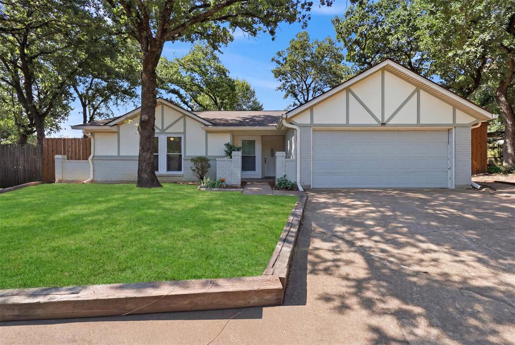 This move-in ready North Arlington home offers 4 bedrooms, 2 full bathrooms, 2 car garage and is tucked away at the end of a cul-de-sac. Recent updates include newer windows, no carpet, and a wood privacy fence, all just minutes from Arlington's top attractions. The spacious living room serves as the heart of the home with vaulted ceilings, tile flooring, and a charming brick fireplace. The open-concept layout flows into the kitchen, featuring granite countertops, stainless steel appliances, ample cabinet and countertop space, and an eat-in dining area overlooking the backyard. The private primary suite includes an ensuite bathroom with dual vanities and a walk-in closet. Three additional bedrooms provide flexibility for family, guests, a home office, or a playroom. Outside, enjoy a spacious backyard with mature shade trees, a large covered patio, two separate seating areas, a storage shed, and plenty of room for entertaining, pets, or play. Conveniently located near parks, shopping, dining, and Arlington ISD schools, with quick access to AT&T Stadium, Globe Life Field, Six Flags Over Texas, Texas Live!, DFW International Airport, Highway 360, I-30, and the Arlington Entertainment District, making commuting throughout the Dallas-Fort Worth Metroplex easy.