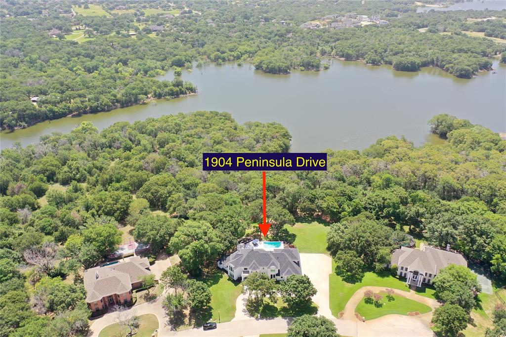 Spectacular 6 bedroom home on over 1.2 acres with direct access to Lake Grapevine. Extensive renovation just completed including new kitchen, bathrooms, pool, roof, HVAC & much more. Custom designer touches, spacious open floor plan & lots of natural light throughout. Oversized primary suite includes a marble master bath, large shower, walk in closet with custom built ins & seating area with gorgeous views of the backyard. Gourmet kitchen is a chef's delight with commercial grade appliances, lots of cabinet space, quartzite counters & walk in pantry. Main office includes built in cabinets & spiral staircase to home gym. Secondary bedroom down. Upstairs offers 4 large bedrooms, game room & bonus room. Lots of storage throughout the home. Recently installed custom pool & spa enhance the backyard oasis. Oversized 4 car garage. 25 miles of hiking & bike trails just steps from your back door. Peaceful & serene location with tons of mature trees. Move in ready & will not last long.