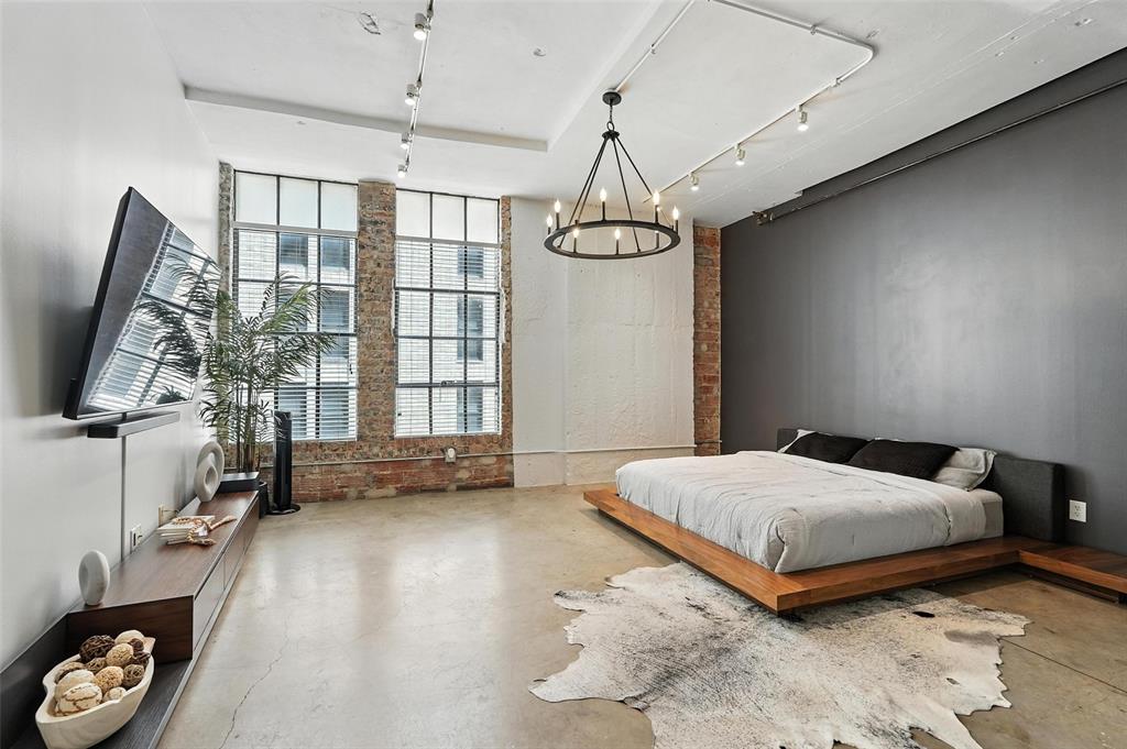 Live in the center of it all in this minimalist, industrial-style studio loft located on the 7th floor of a sought-after building in downtown Dallas. Designed for modern urban living, this open-concept unit features polished concrete floors, sleek stainless steel appliances, and luxurious quartz countertops with matching quartz backsplash—perfect for those who appreciate clean lines and contemporary design. Enjoy the convenience of in-unit washer and dryer connections and the peace of mind that comes with your own assigned garage parking spot, which transfers with the unit. Space has been upgraded to include additional storage and a dedicated office space. Private, climate-controlled storage space assigned to unit is conveniently located on the same floor. Impressive building amenities include a rooftop pool with sweeping views of the downtown skyline, private cabana, a fully-equipped gym, and a separate yoga room. With 24-hour front desk concierge service and on-site security, this building offers a true lock-and-leave lifestyle for busy professionals or those looking for a stylish urban retreat. Don’t miss your chance to own a piece of the Dallas skyline—schedule your private tour today!