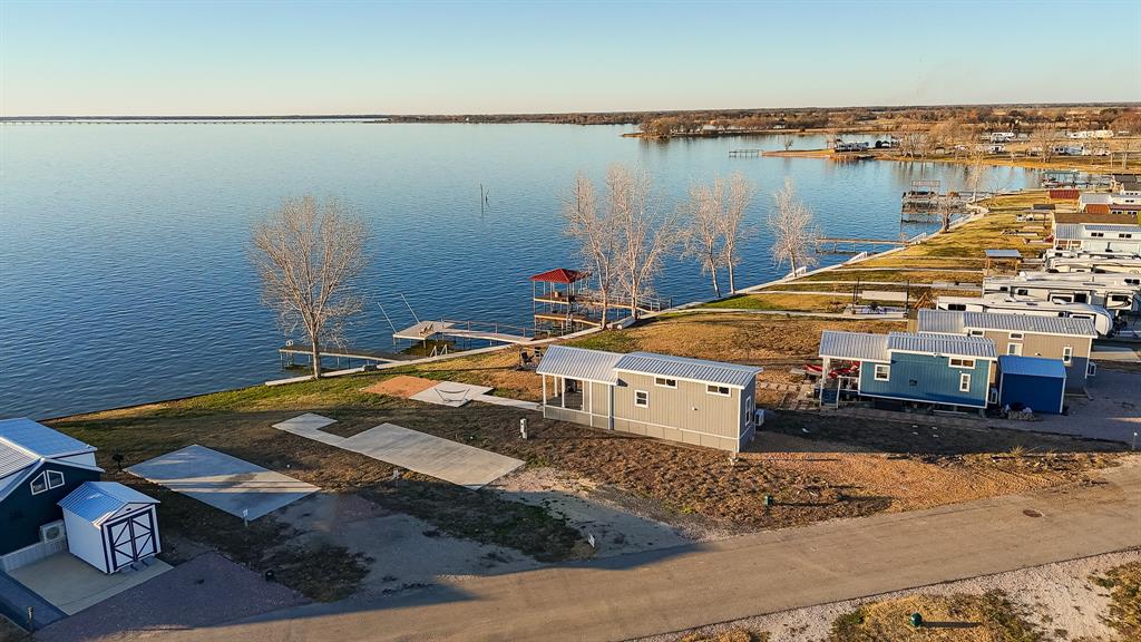 Tiny home right on the water! Come experience simple living in this charming, lakefront tiny home with breathtaking views of Richland Chambers Lake from your private pier. The home has been thoughtfully updated with new kitchen countertops and an updated bathroom, complete with a walk-in shower. The cozy yet modern floor plan offers plenty of space, including an upstairs loft that can serve as a bedroom or bonus room! With amenities like a public clubhouse, pool, boat ramp, and more, Peninsula Point is one of the few communities that allows vacation rentals. Whether you're looking for a peaceful retreat or an investment opportunity, this home is ready to move in or be rented. Come see it today!
