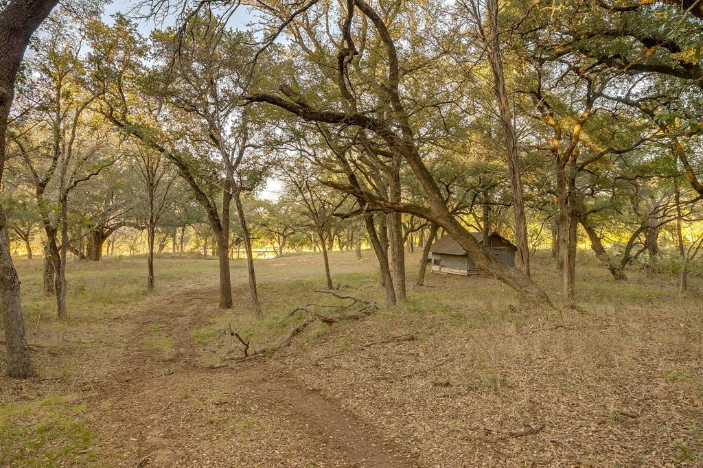 Just over an hour from Dallas Fort Worth, discover an elevated slice of Texas at River Canyon Ranch an intimate, gated ranch community with coveted, private Brazos River access from your own property plus use of a five-acre owners’ river park. This is where wide-open skies meet the 360° ridgelines of the Palo Pinto Mountains, and where weekend escapes turn into lasting legacies. Positioned in a thoughtfully growing enclave, this homesite blends serenity with smart investment. Low carrying costs are assured by Ag Exempt status through the community’s Cattle Grazing Association, and everyday ease comes standard with paved roads, so you can dream big and start building sooner. Design a modern ranch retreat, a full-time residence, or a high performing short-term rental, the setting is tailor made for indoor outdoor living, stargazing decks, and lazy afternoons by the river. Nature is your amenity package, launch kayaks, cast a line, wander canyon trails, or simply watch the sun melt over the hills. Beyond the gates, you’re close enough to DFW for spontaneous getaways yet far enough to feel worlds apart, ideal for buyers seeking Texas riverfront land, gated acreage, low tax ranch property, and Brazos River real estate with year-round appeal. Opportunities like this are limited as River Canyon Ranch continues to mature. Secure your spot on the river, capitalize on the area’s momentum, and create the retreat you’ve imagined.