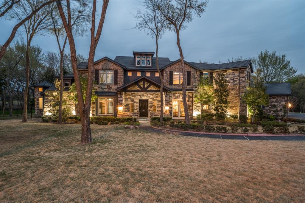 Stunning custom-built home on 3-acre wooded estate in Whispering Farms, Prosper. The expansive driveway provides easy access to the home's grand entrance and leads to a spacious 6-car garage; with room for multiple vehicles and additional storage. Inside, the home has impressive high ceilings and a dramatic two-story stone fireplace. The kitchen is a chef's dream, with an oversized island, farmhouse sink, top-of-the-line appliances and plenty of storage. The master suite is truly an escape with its own fireplace and expansive windows. The main floor also includes a guest bedroom and beautifully appointed office with built in shelving with french doors. The centerpiece of this property is the backyard oasis that includes a 2 story stone fireplace, outdoor kitchen, numerous seating and dining areas surrounding a sparkling pool with a spa. Whether you're looking for a serene escape or a place to entertain friends and family, this property is sure to exceed your expectations.
