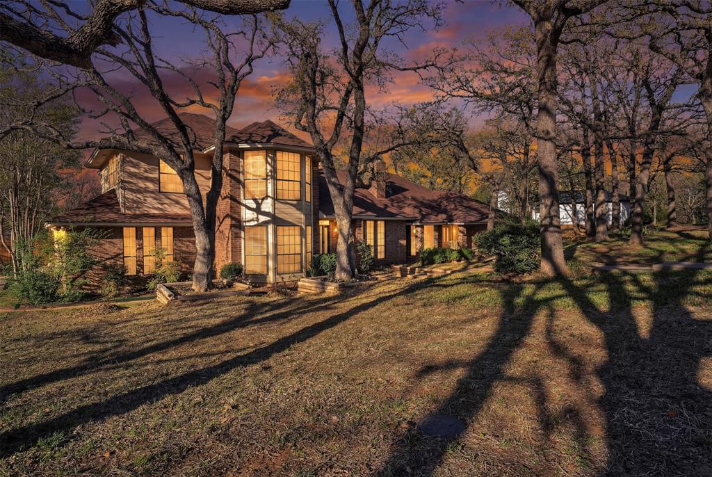 Nestled on a beautifully treed lot in Burleson, this spacious and character-filled property offers the perfect blend of privacy, functionality, and versatility. The main home features 4 bedrooms and 2.5 bathrooms with multiple living and dining areas, creating an ideal layout for both everyday living and entertaining. Rich wood detailing, built-ins, and a cozy brick fireplace add warmth and timeless charm, while large windows bring in natural light and showcase the surrounding landscape.

The kitchen offers ample cabinetry, generous counter space, and a functional layout that opens to the main living areas. Upstairs, additional bedrooms provide flexibility for guests, office space, or hobbies.

What truly sets this property apart is the attached apartment—complete with 2 bedrooms and 1 bathroom—perfect for multigenerational living, guest quarters, or potential rental income. With its own private space, it adds incredible value and opportunity.

Situated on an expansive lot with mature trees, the outdoor space offers privacy, room to roam, and endless possibilities. Whether you're looking for a place to spread out, host, or invest, this one-of-a-kind property delivers.

Don’t miss your chance to own a unique home with built-in versatility in a desirable Burleson location!