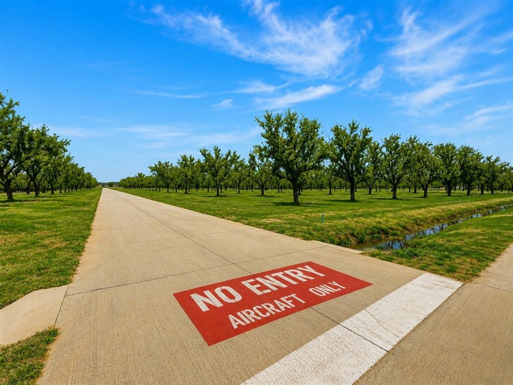 Best-priced aviation lot currently available in The Landings at Pecan Plantation, one of North Texas' most sought-after residential airpark communities! This exceptional 1.5-acre homesite at 1424 Cirrus Loop offers prime positioning with direct taxiway access, providing seamless aircraft movement and efficient departures and arrivals right from your own property. Imagine taxiing directly from your custom hangar to the community's private paved residential runway, no FBO lines, no long drives, just you, your aircraft, and the wide open Texas sky. With generous acreage and flexible building space, this lot is perfectly designed for a custom hangar home featuring an expansive hangar, luxury residence, private workshop, and resort-style outdoor living, all tailored to your vision. Pecan Plantation is a gated, guarded master-planned community in Granbury, TX, home to a thriving pilot community and an extraordinary array of resort-style amenities: championship golf courses, full-service marina on Lake Granbury (Brazos River), clubhouse dining, swimming pools, tennis, pickleball, basketball, baseball & soccer fields, disc golf, fitness center, archery range, equestrian stables, campgrounds, scenic parks, walking & jogging trails, year-round social events & activity classes. All everyday conveniences are inside the gate, grocery store, gas station, bank, barber, hair salon, pizza parlor, bistro, and dedicated on-site EMS & fire department. Just minutes from the Historic Granbury Square with boutique shopping, dining & entertainment. Whether you're an active pilot or aviation enthusiast, this is a rare opportunity to own the best-priced fly-in lot in the development. Build the ultimate hangar home and aviation lifestyle you've always envisioned. Secure your place today!