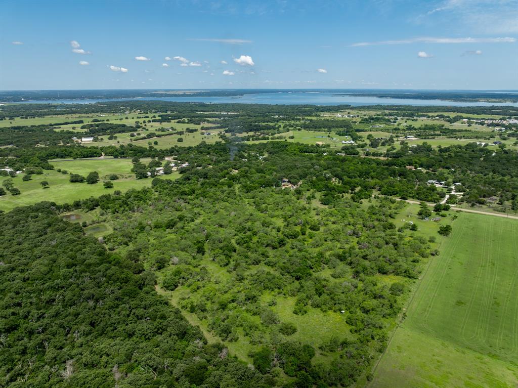 Escape to the peace and tranquility of country living on this beautiful 55.16-acre property near Lake Whitney. Offering an ideal blend of open pastureland, scattered mature trees, and a dense forested area along the rear of the property, this acreage provides both beauty and privacy in a picturesque rural setting. The property features multiple ponds and stock tanks, enhancing both the landscape and its recreational appeal. Wildlife is abundant, with deer and wild boar frequently seen roaming the property, making it an excellent choice for hunting, wildlife observation, or simply enjoying nature. Whether you’re looking to build your dream home, establish a weekend retreat, create a recreational getaway, or invest in a piece of Texas countryside, this property offers endless possibilities. Enjoy the quiet surroundings, wide-open spaces, and natural beauty while remaining conveniently close to Lake Whitney and within reach of nearby towns.
If you’re searching for a place to escape the urban hustle and bustle, relax under the stars, and enjoy the peaceful rhythm of country life, this exceptional 55.16-acre tract is a must-see.