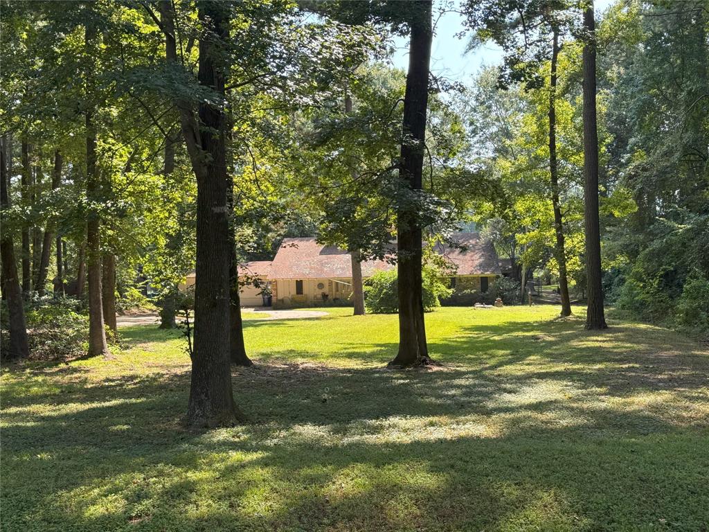 This single-family home built in 1985 with 3 bedrooms and 2.5 bathrooms, featuring a two car attached garage, a fireplace, and hardwood, tile, and carpet flooring. Appliances include dishwasher, garbage disposal, microwave, range oven, refrigerator.  Central AC Heating with a backup home generator. The home is situated on 1.26 acres of land with approximately 200 Feet of Lake Front.  The property offers direct access to the lake, with a dock and boat cover.