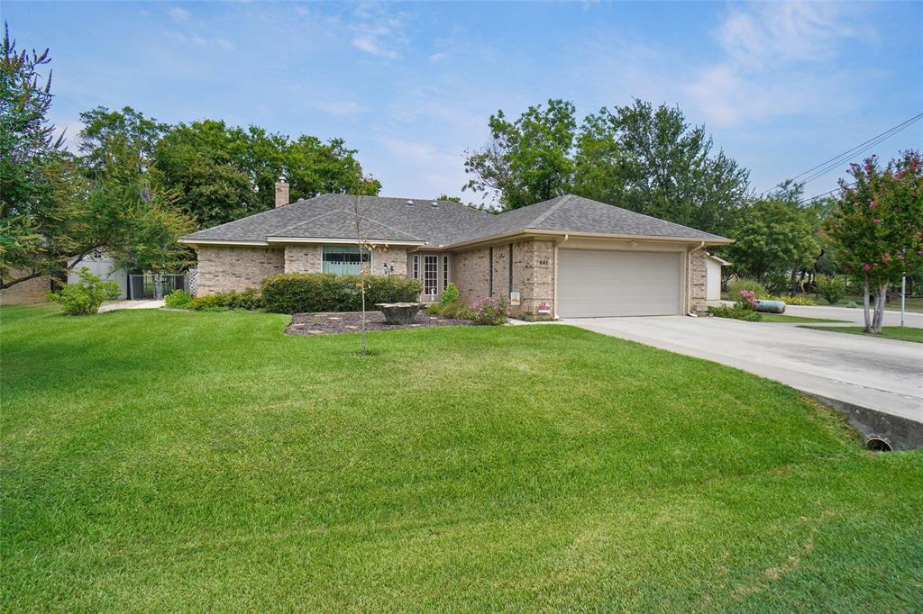 Discover this Home which sits on 2 LOTS with 3 bedrooms, 2 baths and 2 car garage AND a detached LARGE SHOP 24x40. The home has NEW AC-Heat with NEW Duct Work & a NEW ROOF!!! Step into the foyer and walk into the living room with high ceilings and a fireplace. Large Primary Bedroom & Bathroom with 2 vanities with his & her closets. Extra bedrooms are large with nice big closets. A standout feature is the SHOP, which can be used for storage, hobbies, or a man cave or parking all your toys. Shop has a cement floor, electric, air & heat, insulated, work cabinets, double garage door with separate entrance door and RV hookup. Nice backyard with closed in patio, Pergola 11x22, fenced, sprinkler system, trees and landscaped. Home sits on a Greenbelt Area creating a quiet retreat with No Backyard Neighbors. Property is minutes from Lake Bridgeport & Boat Launch. Located in the city of Runaway Bay, the city has a community pool, swimming beach & fishing pier. EZ access to Highway 380, located less than 10 mins from the Historic Bridgeport Main Street. Alliance Town Center, Southlake, DFW Airport, Downtown Fort Worth are about an hr away. See this HOME soon!