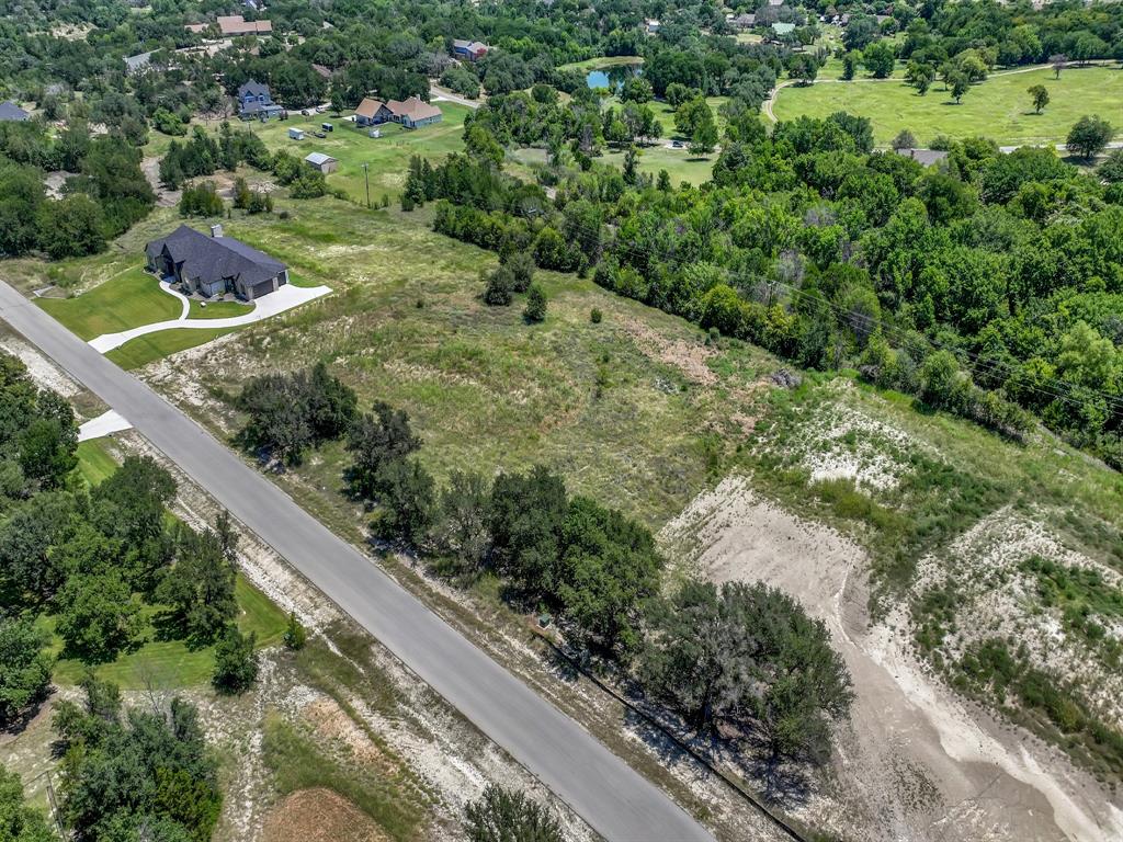 ONE OF THE MOST DESIRABLE LOTS in Aledo Bluffs - an upscale, gated community in ALEDO ISD. Don't miss your chance to own one of the last remaining lots in the prestigious, gated community of Aledo Bluffs located in the highly acclaimed Aledo School District! The scenic drive into the neighborhood featuring rolling hills and breathtaking views is truly unmatched. With privacy, space and natural beauty, this rare homesite is the perfect place to create your dream home! This lot is in the perfect location within the community as it is an interior lot with huge picturesque oak trees at the front of the lot and privacy trees at the rear of the lot. Additionally, the lot is wide and flat lot with a natural clearing in the middle for a potential homesite. Enjoy peaceful living with a quick commute to downtown Fort Worth and just minutes to shopping and restaurants! AT&T FIBER INTERNET. No time frame to build, choose your own builder, unincorporated (NO CITY TAXES), LOW HOA fees, and no water bills (well & septic required)! See Transaction Desk for Plat and Covenants.