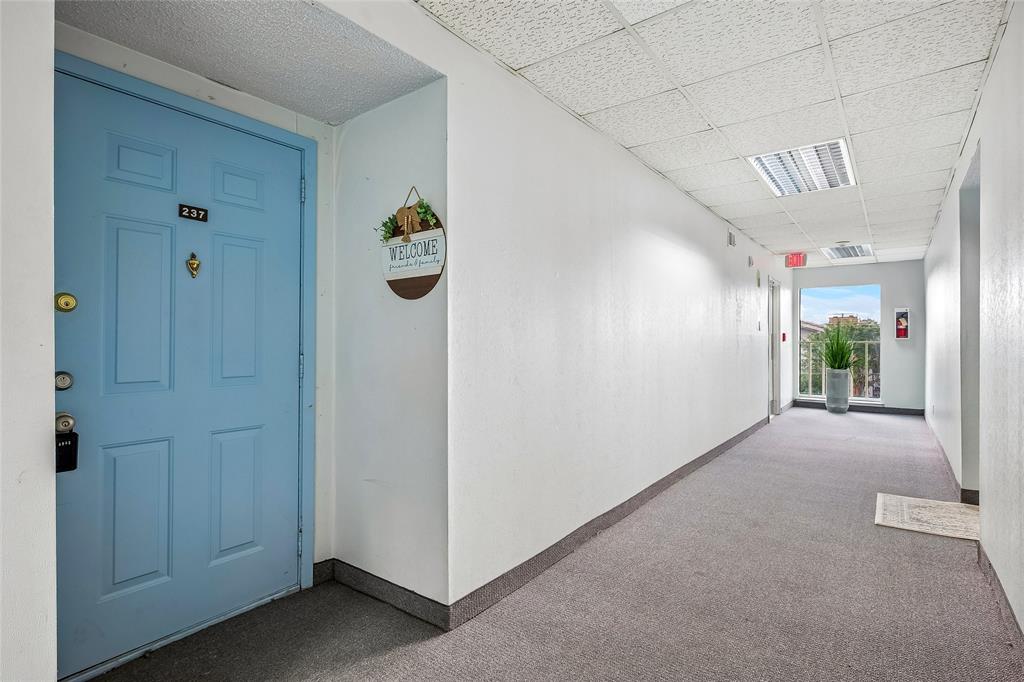 Welcome to this charming second-floor condo, ideally positioned with relaxing views of the community pool and tennis courts beyond. Vacant and move-in ready, this home offers a wonderful combination of comfort, convenience, and security.

Residents enjoy controlled access with regularly updated gate and building entry codes, and a guard is often stationed at the community entrance for added peace of mind. Hallway carpeting throughout the community is also being updated, with this building scheduled in an upcoming phase.

The thoughtfully designed floor plan is ideal for roommates, guests, or those seeking additional privacy. Two spacious bedrooms, each with its own full bath, are situated on opposite sides of the home and separated by a generous living area. The living room features a cozy corner electric fireplace and opens to a bright sunroom that serves perfectly as a home office, reading nook, exercise space, or hobby room.

The open-concept layout allows the dining area to flow seamlessly into the living room, while the kitchen offers a convenient serving bar and includes the refrigerator. The primary suite features a private balcony, an updated walk-in shower, and ample closet space.

Additional highlights include abundant storage throughout and full-size washer and dryer connections. Pet owners will appreciate the nearby dog park located just steps from the building. One covered parking space is assigned and there is plenty of open guest parking. HOA covers water, exterior maintenance, community pool, tennis courts, dog park, security gate, common grounds, and management fees.

Whether you're a first-time buyer, downsizing, or seeking a low-maintenance lifestyle, this inviting condo is ready to welcome you home.

Note that the photos are virtually staged. Current rent for this unit is $1,350-mth