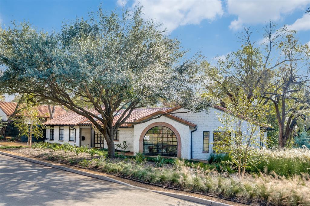 A Forest Hills treasure, originally designed by esteemed Dallas architect Clarence C. Bulger for Dr. Robert Karper, this rare residence seamlessly blends preserved historic charm with the luxury and efficiency of all-new construction. Thoughtfully restored and completely rebuilt between 2024–2025, the home honors its 1940s character while integrating every modern comfort.

Upon arrival, a sweeping front lawn framed by mature trees welcomes you to a storybook façade with restored steel windows and a newly engineered tile roof. Inside, sunlight fills open, refined living spaces designed for both elegance and everyday ease. The reimagined layout offers multiple living areas—including a versatile lower-level suite perfect for a media room, home office, or guest retreat.

The kitchen, anchored by a large island and breakfast bar, features custom Amcraft cabinetry, undercounter wine fridges, a hidden pantry with built-in refrigerator drawers, and premium appliances ideal for gourmet entertaining. Three ensuite bedrooms and an additional half bath offer privacy and sophistication, complemented by curated finishes from Pierce Hardware. Every major system—plumbing, electrical, HVAC, and structural—has been newly installed with uncompromising quality. Concrete driveways and walkways, reinforced roof framing, and superior foam insulation ensure comfort, efficiency, and long-term durability. The property includes a detached three-car garage, automatic gated entry, and lush, thoughtfully landscaped grounds. Perfectly positioned near White Rock Lake, the Arboretum, and scenic biking trails, this home embodies the rare harmony of architectural heritage and modern luxury. A truly move-in ready masterpiece—offered furnished if desired.
