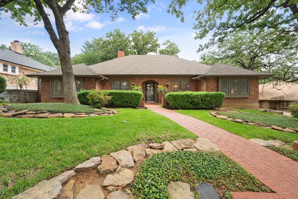 Nestled on a quiet cul-de-sac in the highly desirable Huntwick community, this charming home offers exceptional curb appeal with mature trees, lush landscaping, a brick walkway, & a welcoming front porch. Inside, you'll find generously sized rooms throughout, enhanced by fresh interior paint & abundant natural light. The spacious living room features elegant painted picture-frame paneling, extensive built-in storage, & a beautiful brick gas fireplace with gas logs. An adjoining enclosed porch with wraparound windows creates a bright & inviting space that can serve as a second living area, perfect for relaxing while enjoying views of the backyard. The oversized kitchen is designed for both functionality & entertaining, offering ample counter space, double ovens, abundant cabinetry & a breakfast bar. Ideally situated between the formal dining room & breakfast area, the eat-in also benefits from a built-in buffet. A versatile oversized bedroom located in its own private wing offers endless possibilities as a mother-in-law suite, game room, second living area, home office, or flex space. Built-in bench seating adds character, while a nearby full bathroom conveniently serves both this room & main living areas. The private primary suite overlooks the backyard featuring French shutters along with direct access to the enclosed patio. The en-suite bathroom includes dual vanities, a separate shower, & two generously sized walk-in closets. Two additional secondary bedrooms are situated in their own wing with a shared full bathroom. One of the front-facing bedrooms includes a walk-in closet & charming built-in bench seating. Outside, the beautifully landscaped backyard provides a peaceful retreat complete with a gazebo. A long driveway leads to the rear-entry garage, offering additional privacy, security & curb appeal. This well-maintained Huntwick home combines spacious living, flexible floor plan options & timeless charm. Roof & gutters installed in 2026.