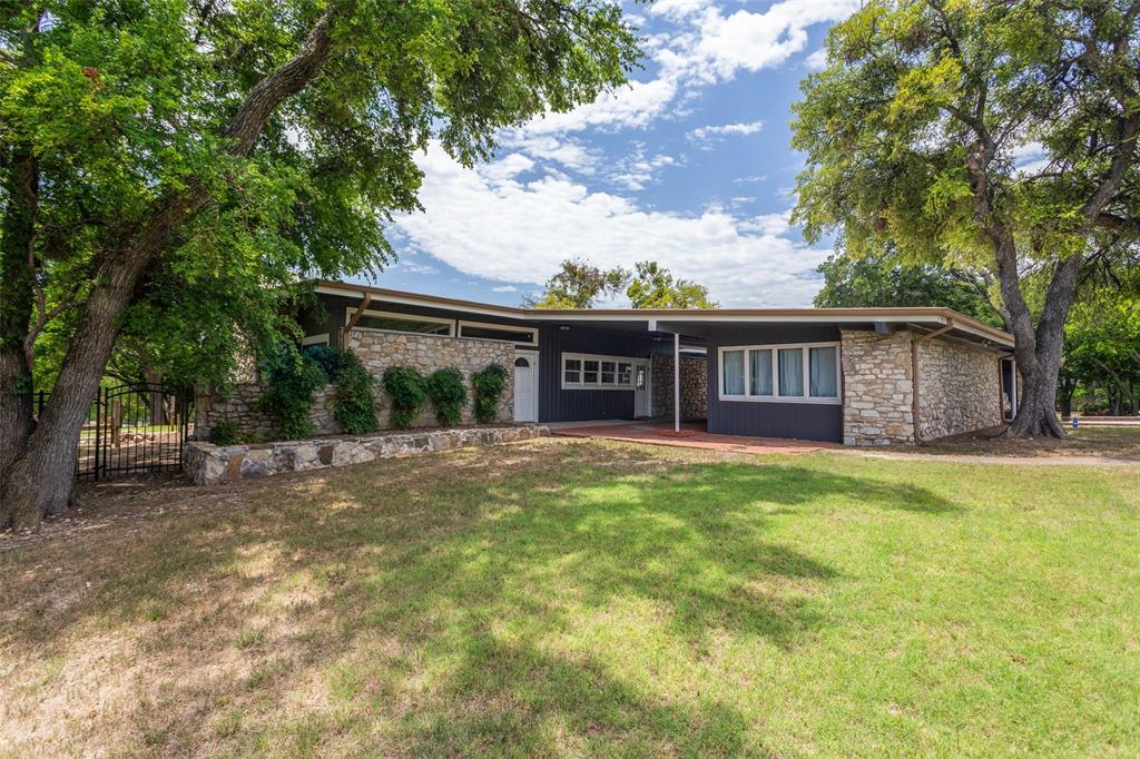 ATTENTION FLIPPERS & INVESTORS!!! THIS HOME IS PRICED FOR YOU! There is huge potential here after some work is done. BEAUTIFUL LOT WITH TREES set on top of a small hill, with lake view from the front yard! The home does need extensive foundation work and updating BUT priced accordingly!. Very large open living area with wood burning fireplace open to kitchen and dining area. The back wall of the house is full of windows allowing for a nice view of the gorgeous backyard setting! AND there is a guest house of approx 420 sf NOT in the house square foortage of approx 2400. The guest house has its own sleeping area, small den, bath, and kitchenette! The home does have an enclosed workshop next to the carport. The land is beautiful and this could be a prime home for the buyer that wants to put in the time and dollars for the needed repairs and updates! Foundation report available. Seller estimates $30-40k needed in foundation work.