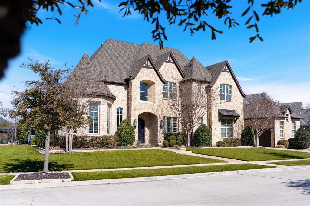 You’ll be smitten from the moment you arrive. Tucked inside exclusive Carillon, just minutes from Southlake Town Square, this stunning estate delivers true resort-style living without ever leaving home. A dramatic two-story entry, sweeping staircase, Juliet balconies, soaring great room, statement fireplace, walls of windows, and breathtaking views of the backyard oasis all come together beautifully across an oversized lot - a rare find. The kitchen is designed for gathering, centered around an expansive island complemented by custom cabinetry, designer vent hood, 6-burner gas cooktop with griddle, stunning countertops and backsplash, Sub-Zero, SS appliances, breakfast area, and walk-in pantry. An adjacent butler’s pantry connects seamlessly to the formal dining room for effortless entertaining. The primary suite is a retreat all its own, featuring an elegant barrel ceiling and cozy curved seating area. A spa-like bath invites pure relaxation with dual vanities, dramatic triple-window walk-through shower, deep soaking tub, and impressive custom closet with built-ins + wardrobe cabinetry. Outside is where the magic really happens. Unwind to the sound of a natural rock waterfall cascading into the pool & spa, surrounded by an expansive deck, covered patio with built-in grill, gas griddle. An adjacent two-story seating area and inviting outdoor fireplace are perfect for cozy evenings and game-day gatherings. An elevated, rotunda-style office sits at the front, with a private guest bedroom + ensuite on the main level, along with a media room with tiered seating and a home gym-flex space with patio access  + bonus storage. Upstairs find 3 additional bedrooms with ensuite baths surrounding a spacious gameroom, play area, beverage bar, and powder bath with room for game tables, movie nights, and more entertaining fun. Two separate entrances into an oversized laundry-mudroom from the 4-car garage + storage for bikes & workbenches. Sophisticated. Spacious. Simply Unmatched.