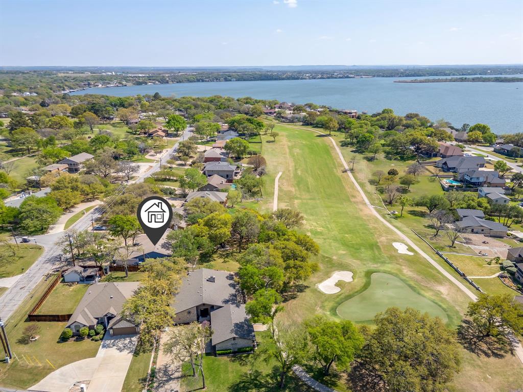 GOLF COURSE LOT located in DeCordova Bend Estates on the 18th hole and steps away from the club house. Property is Move-In ready but could use a little updating. Price has just been dropped again to reflect this. GREAT LOCATION & LOT. Features: Covered back porch, gutters, circular driveway. Living Room is large and open to the dining area and kitchen. Windows across the back of the home faces the golf course and provide great light throughout. Fireplace in LR with built-in shelves. Kitchen has huge amount of counter space and a built-in China cabinet, beautiful counters and many cabinets. Great area for entertaining. Separate Utility Room. Primary bedroom is very large with 2 walk-in closets and is split from other two bedrooms. Garage has 3 doors with two doors facing the front and the golf cart area facing the side. Front Porch has a courtyard area.  
There is a $10,000 buy-in & transfer fees to the club that is to be paid by the buyer. No Survey. Buyers will need to pay for a Survey if one is required.