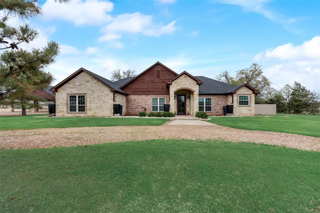 New price on this fully improved 6-acre Bonham property — now offered at $749,900. Pool, pond, barn, and flexible living space make this property stand out from the start. This custom 2004-built stone-and-cedar home offers approximately 2,800 square feet with 3 bedrooms, 2 baths, 2 living areas, a dedicated office, formal dining, breakfast area, and laundry room. Interior features include vaulted tongue-and-groove ceilings, a gas stone fireplace, and a decorative tin ceiling in the secondary living area. The primary suite includes 3 closets and an updated bath. Outdoors, enjoy a gunite pool with waterfall, covered patio with string lights, and a stocked pond shaded by mature pecan trees. The covered barn includes 3 oversized 24x24 stalls with concrete flooring, comfort matting, power, water, and fans, plus adjoining open-bay storage for hay, equipment, or trailers, and a fenced chicken coop at the rear. A separate decorated metal container with power and AC is currently used as a she-shed and project workshop. Additional improvements include equipment storage, a storm shelter, a 3-vehicle covered carport, mature pine-lined gravel drive, and fully fenced perimeter. Bois d’Arc Lake is a short drive away. Ready to enjoy from day one.

Equipment storage, storm shelter, and 3-vehicle covered carport round out the outbuildings. Mature pine-lined gravel drive, fully fenced perimeter, aerobic septic, short drive to Bois d'Arc Lake. Rural Bonham ISD living, ready to enjoy from day one —Bring your horses, your boots, and your appetite for space, comfort, and country living done right.

Photos can show the pool, the pond, and the oaks — they can't show how quiet it gets at sunset, how the barn breeze moves through the stalls, or how the whole place lives day to day. Schedule a private showing and walk it. Several rooms are staged to inspire your own design vision, and the workshop container will be open during your visit.