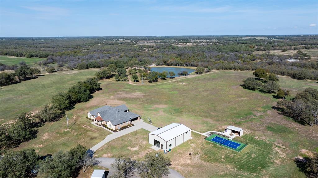 The Lazy B Ranch represents a unique opportunity to purchase a turnkey ranch where the current owner has done the work so that the new owner can simply enjoy. The main house is a 5BR 5.5B, 4,639-sf custom home built in 2011 and renovated in 2021. This house is straight out of a magazine and comes fully furnished. Located near the main house is a fantastic 40x60 party barn with a wet bar, video wall, poker table, shuffleboard table, ping pong table, pool table, and a large u-shaped couch. There is also a private gym and a movie room upstairs. Located next to the party barn is a lighted pickleball court. A barn and shop is located near the entrance of the ranch. The barn is used for storing farm and ranch implements and there is a livestock working facility adjacent to the shop. The current owner has built approximately three miles of new roads on the ranch and installed a number of new culverts.

The wildlife on the ranch is abundant. Deer, turkey, and hogs are all prevalent on the ranch. Ducks and geese are also fond of the flooded habitat and many water features found on the Lazy B.

The crown jewel of the many water features that can be found on the ranch is the completely rebuilt 2.2+-acre fishing pond located just beyond the house. The pond was reworked to increase both size and depth, with the maximum depth now being approximately 30 feet. The terrain is very diverse on the ranch and the elevation change is approximately 110 feet. Parts of the ranch contain planted fields and food plots, while other areas feature deep canyons, mature timber and creek bottoms. The mix of open pasture to wooded cover on the ranch is ideal. The property is enrolled in a federal program known as Pastures for Upland Birds.  Over 50% of the pastures have been replanted in native grasses with a focus on quail habitat.  The remaining pastures will be planted over the next few years under the program with the completion expected in 2 years.