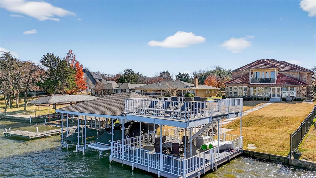 Located inside the gated lake and golf course community of Lake Kiowa, this beautifully renovated waterfront home is ready to enjoy. Near the east beach and positioned just inside a no-wake zone, the property offers quick access to open water in a peaceful setting.

The main level features a spacious primary suite with lake views and a luxurious en suite bath with a walk-in double-headed shower, soaking tub, dual vanities, and a seated makeup area. A second downstairs suite includes a private full bath and space for a sitting area and a child’s bed, while a third first-floor bedroom provides convenient guest accommodations.

The open kitchen flows into the living and dining areas and includes a double oven, ice maker, warming drawer, two beverage refrigerator drawers, walk-in pantry, and oversized island with seating. A full bath near the back door offers easy access after time on the lake. Just off the living area is a wine room with built-in refrigeration, cabinetry, and seating.

Upstairs features a light-filled office area, a large game room with a balcony overlooking the lake and a Murphy bed, four additional bedrooms, three full bathrooms, a second laundry area, and a kitchenette with beverage drawers and coffee bar.

Exterior highlights include a Spanish tile roof, spider misting system, exterior lighting, and a path to a newly built two-story boat dock with boat lift, two double jet ski lifts, and multiple seating areas.

Lake Kiowa offers unlimited golf on a PGA-rated 18-hole course and a par-3 course, a private lake with minimal traffic, 24-hour gated security, restaurant with 19th hole, walking trails, and two beaches — delivering true resort-style living.