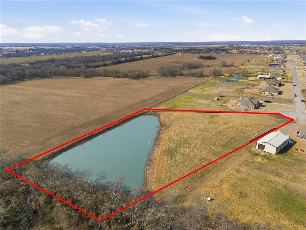 Your dream home site awaits! Just over 2.5 acres with a stunning 1-acre pond, offering the perfect backdrop to build your custom home. Situated on a quiet cul-de-sac lot, with trees, creating privacy and a serene country setting. Located in sought-after Caddo Mills ISD, this property offers the ideal blend of peaceful country living with convenient access to town. Enjoy the freedom of NO HOA and NO city taxes — bring your vision to life without restrictions. The water meter is already installed (a $3,500 value), and the seller has recently cleared saplings from the pond, saving you time and money. With ample space for your dream home, shop, outdoor entertaining area, and more, this property is the perfect blank canvas to create your ultimate retreat.