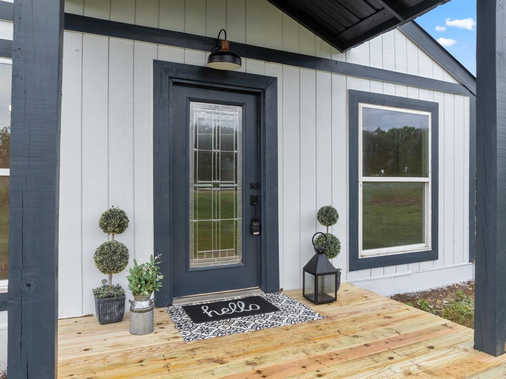 AFFORDABLE, SITE BUILT 5 bedroom HOUSE on 1 ACRE with room for everyone! Come live the relaxed, simple life outside of city limits with NO HOA and the freedom to raise farm animals. Let your kids run wild and bring your big dining table along with loved ones to this spacious, open concept layout where there's room for gathering inside and outside. You will love the abundance of windows allowing natural light in while enjoying views of country life.  Oversized 30ft side porch is made for relaxing in a shady spot on a breezy day.  Master retreat located at the back of the house with oversized ensuite bathroom and double closet. Newer built, freshly painted in and out, and new carpet in bedrooms.  Located conveniently between I35E & I 35W for quick and easy access to Dallas, Fort Worth or Waco!  Bring your horses! Wardrobes will convey.