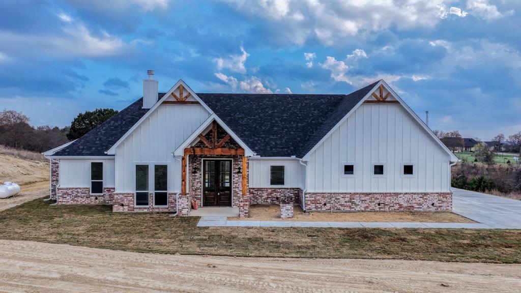 This proposed Ava plan features 3 beds 2 full baths, a convenient half bath, with a dedicated office on 2ac & 2 car garage. Step inside to a generous living area that seamlessly flows into the dining & kitchen spaces. The inviting living room is accentuated by built-in shelving, a cozy fireplace, & large windows that fill the space with natural light while offering picturesque views of the backyard. The Kitchen has abundant storage, granite or quartz countertops, an eat-at-island with custom painted cabinetry, stain grade available for upgrade. Master bedroom features a soaking tub & fully tiled shower trimmed in frameless glass. Take advantage of NO PAYMENTS while you build with Zeal Home Builders! The Ava plan is fully equipped with all the features one would expect from a custom home, including split bedrooms, spacious porches, custom cabinetry and closets, Delta faucets, a concrete driveway, decorative mirrors, wall-mounted TV outlets, & hardline Ethernet ports. The builder has invested in high-quality details such as spray foam insulated walls and more. The two-car garage is thoughtfully designed with can lighting, a smart MyQ side-mount garage motor, and an auto-lock system for added security. Enjoy the freedom of no HOA and no city taxes! Outside, expansive porches greet you, featuring solid cedar-stained columns that create an inviting first impression. Upgrade to include a full outdoor grilling area! Just 10 min to Lake Granbury Marina & 15 min to the historical Granbury Square boasting dining, shopping, local events, wineries, live music & more. This home offers the perfect blend of modern living and rural tranquility. With a wide range of options at your disposal, you can tailor it to suit your unique needs. Estimated completion 6-7 months from start to finish. Images depicting a model home. Features & finishes are subject to change. Txt keyword ZHB22 to 88000 for Virtual Tour & builder details.
