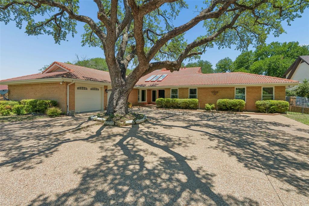 Welcome to one of Eagle Mountain Lake's most compelling opportunities. This beautifully updated 3BD, 4BA brick home delivers 3,238 sq ft of refined lakefront living on nearly half an acre, where rich vinyl floors, a striking stone fireplace with built-ins, and lake views from nearly every room set the tone from the moment you walk in.

The galley kitchen impresses with granite countertops, stainless appliances, and a gas range, flowing seamlessly into a spacious dining area and a dedicated wet bar, perfect for entertaining. The oversized primary suite features direct outdoor access and a spa-inspired bath with a walk-in tile shower and granite vanity.

Step outside and the property truly shines. The two-story boat dock house is a lakefront entertainer's dream in the making. The covered lower level houses a full boat slip with lift system. Above, a generous 500 sq ft second-story living space features a living area plus a detached restroom for ultimate convenience. A hot tub, extended fishing pier, and open sun deck round out this incredible waterfront complex, all framed by panoramic Eagle Mountain Lake views.

The dock does need renovation, but the infrastructure, the space, and the views are all there. Here's the opportunity, this property is priced below comparable lakefront homes with updated docks. Invest in the repairs, build instant equity, and end up with a full resort-style retreat on Eagle Mountain Lake for a fraction of the cost.

The lake is calling. The home is ready. The upside is yours. Come out and have a look today!