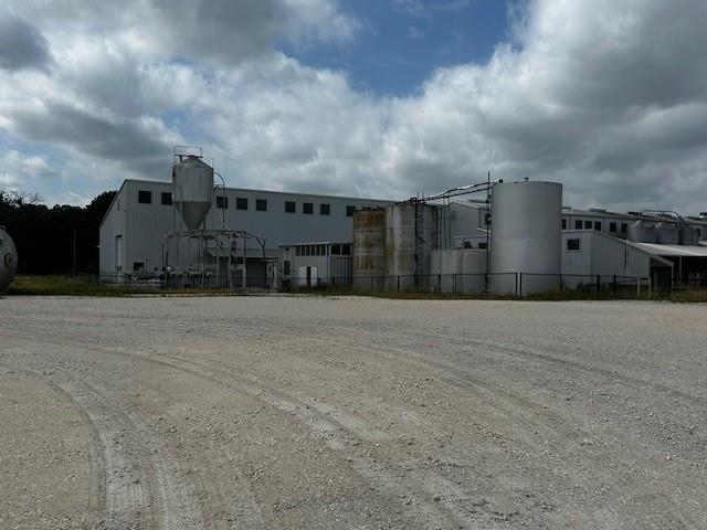 Positioned on 6.385 acres in the growing Granbury corridor, 5650 Matlock Rd presents a rare opportunity to acquire a versatile manufacturing property designed for both functionality and future scalability. This site strikes that hard-to-find balance between operational efficiency and long-term upside—whether you’re expanding an existing operation or establishing a new footprint in Hood County. At the heart of the property is a well-appointed office space, providing a professional hub for administrative operations, client meetings, and day-to-day management. A covered outdoor pavilion offers flexible use for team gatherings, equipment staging, or workflow overflow—ideal for operations that don’t fit neatly inside four walls. Nearby, a dedicated loading and unloading area supports efficient logistics, allowing for streamlined movement of materials, equipment, or product—an essential feature for any serious manufacturing or distribution use. There is also 3 phase power. The acreage itself is where the long-term vision comes into play. With over six acres, there’s ample room for expansion, additional structures, storage, or yard space, giving owners the flexibility to grow without relocating—a strategic advantage in today’s market.
