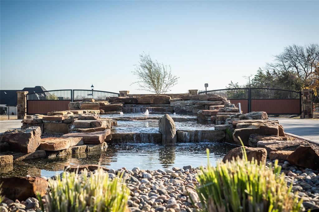 Exceptional 6+ acre luxury estate homesite located within a private, gated community. This premier build-to-suit lot backs to a serene neighborhood pond, offering scenic views, privacy, and a peaceful natural setting. The property is ready for construction and allows buyers to select an HOA approved builder to create a custom residence. Community guidelines require a minimum home size of 5,000 square feet, preserving the integrity and value of surrounding luxury estates. Horses and llamas are permitted, making this a rare opportunity to combine refined estate living, acreage, and gated privacy in an established luxury neighborhood.
