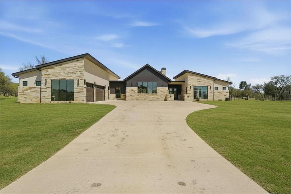 Introducing Ranger Ridge, where refined luxury meets the untamed beauty of the Texas landscape, offering an unparalleled lifestyle designed for the outdoor enthusiast who desires effortless elegance. Experience the rare opportunity to live on a working ranch, without any of the work, where every detail is curated for comfort, convenience & elevated living. Perfectly positioned just one hour west of Fort Worth, this exceptional, fully furnished, turn-key custom estate invites you to step into a lifestyle as seamless as it is sophisticated. Situated on a premium corner homesite backing to a tranquil creek and just a short stroll to the community center, the setting is as serene as it is convenient. Thoughtfully designed by MK Homes of Weatherford, this stunning residence showcases impeccable craftsmanship & timeless design. Inside, hand-scraped hardwood floors set the tone for the expansive, open-concept layout. The home features four spacious bedrooms, a charming bunkroom ideal for guests or gatherings, a private study plus an entertainer’s dream game room complete with a custom bar. Chef’s kitchen is nothing short of spectacular, perfectly suited for both intimate dinners and large-scale entertaining. Indoor and outdoor fireplaces create warm, inviting spaces year-round, while the outdoor kitchen and covered patio offer a true extension of the home, ideal for taking in the sweeping ranch views. Ranger Ridge redefines ranch living with over 3,000 acres of rolling pastures, including 800+ acres of estate homes, offering a private, resort-style experience unlike anything else. Residents enjoy exclusive access to country club-style amenities, concierge services, a helipad, equestrian facilities, stocked fishing ponds, and the extraordinary sight of over 50 exotic species roaming the preserve, creating a one-of-a-kind, immersive outdoor experience for the entire family. Ideally located near Palo Pinto State Park, Possum Kingdom Lake, and The Cliffs Resort Golf Course.