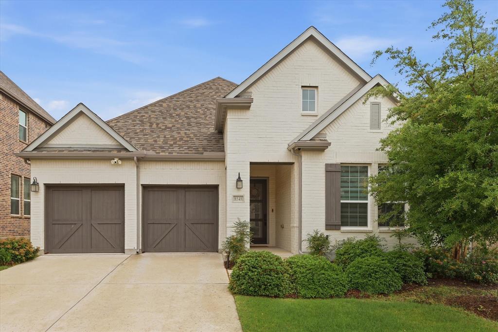 Beautifully designed modern one-story home located in the highly sought-after Southern Hills at Craig Ranch, featuring 3 bedrooms, 2.5 bathrooms, and a private office with elegant double French doors. Thoughtfully designed with split bedrooms and a separate office space, this layout offers both privacy and flexibility for today’s lifestyle. The striking, white-painted brick exterior and clean architectural lines create timeless curb appeal. Inside, the open-concept floor plan is filled with natural light from an abundance of windows, creating a bright and inviting atmosphere throughout the home. Rich engineered wood flooring flows through the main living areas, adding warmth and sophistication. The gourmet kitchen overlooks the spacious living and dining areas and features extensive quartz countertops, a large island, ceiling-height white cabinetry, stainless steel appliances, a gas cooktop and vent hood, stylish pendant lighting, and abundant storage. The spacious dining area and cozy breakfast nook make the home ideal for both everyday living and entertaining. The living room offers a seamless indoor-outdoor feel with large windows overlooking the private backyard. The thoughtfully designed primary suite features a spa-inspired bathroom with dual vanities, a freestanding soaking tub, oversized glass shower, and modern finishes. Step outside to the covered patio and enjoy the peaceful backyard with no direct rear-facing neighbors, offering added privacy and a quiet setting for relaxing or entertaining. Additional highlights include designer lighting throughout, and convenient access to Hwy 121, shopping, Golf, dining, and entertainment. A beautifully finished home that combines modern style, comfort, and functionality in one of the area’s most desirable communities.
