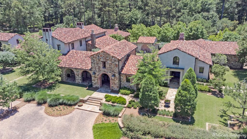 Stunning villa on nearly 3 acres of beautifully landscaped grounds just minutes from Forbing Ridge Shopping District, new YMCA, Line Ave, Youree Drive, La-3132 and I-49.  This one-of-a-kind masterpiece drawn by architect, Ben Patterson, features:  Santa Barbara roof, reclaimed Cypress cabinets, beams and trim throughout, natural stone floors, grand entertaining areas with island that seats 12, La Cornue Range and so much more.  Soaring windows frame views of the private pool and patios throughout the home.  Guest bedrooms are remote and include ensuite bath with separate kitchen & living area.  Don't miss the opportunity to make this exquisitely crafted home your own today!!