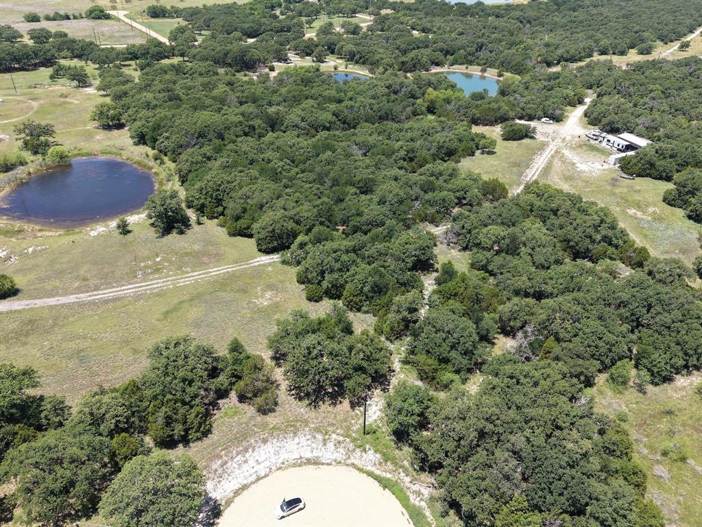 Experience the peaceful and quiet country living Northwest of Ft. Worth in Jack County. The property is a 5 acre wooded tract featuring mature oaks, cedar, and other native trees. The fairly level terrain offers and idea homesite for your retirement home or weekend getaway. Enjoy access to a shared stock tank loaded with catfish, bluegill, and bass. Weather you are looking to build now or invest in the future, this property offers the perfect blend of seclusion, recreation, and accessibility. An additional 5 acres is also available for purchase.