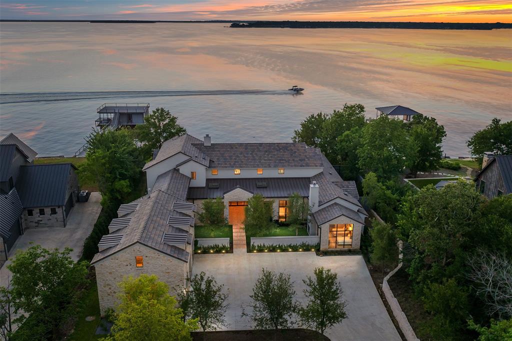 Poised on a coveted 1.07-acre open-water expanse, this newly built transitional lake estate, crafted by premier Dallas builder Jennifer Duncan and Lloyd Lumpkin Architect, redefines waterfront living. Every detail is thoughtfully curated to dissolve the boundaries between indoors and out—sunlight spilling through walls of glass, warm natural wood accents softening the modern lines, and a palette of textures enriched by designer lighting, statement wallpapers, and bespoke cabinetry. The main level is anchored by a tranquil primary suite, a private sanctuary with lake views, while three additional guest suites offer uncompromising comfort. Upstairs, a spacious bunk room welcomes family gatherings, and a game room above the three-car garage seamlessly adapts to work, play, or retreat.

Escape, explore, and enjoy a lifetime of memories at the 505 Ranch-all only 45 minutes from Downtown Dallas. Experience luxury lake living with amenities such as: the equestrian center and riding arena, ATV trail, skeet range, clubhouse and pool, guest cottages, fishing, sailing, and much more.