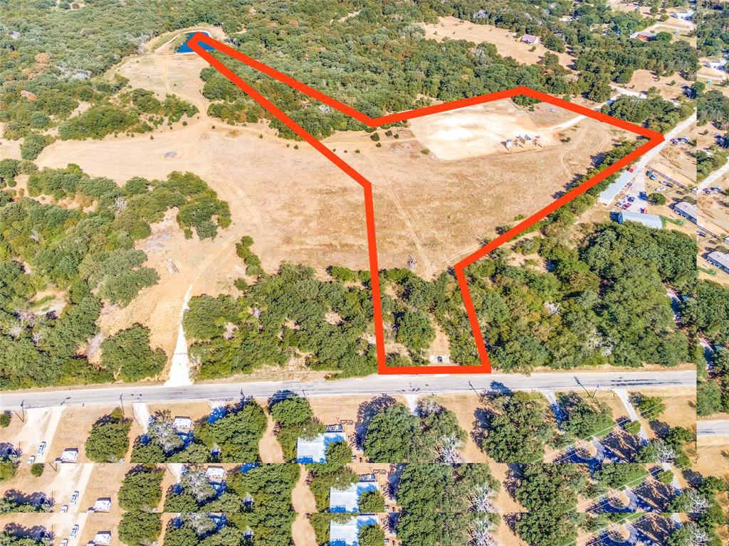 County land with no HOA! Large oak trees, many deer, a secluded space with shared-ownership of the deep pond for fishing! Horses permitted! Culvert with small driveway on CR401 and an additional entrance driveway on Greenfield is already there! Great road frontage and easy access to I-35. Gas Well has building restrictions with no build within approximately 300' - See plat in transaction desk for reference. (Boundary lines on photo are approximate and subject to approval.) Can possibly be combined with 9+ acre parcel next to it.