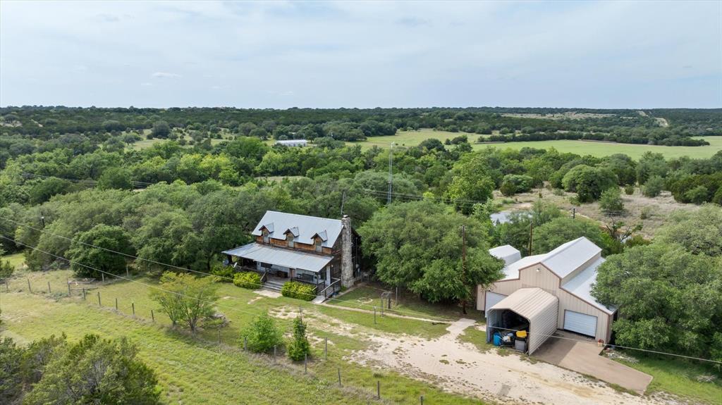 Gorgeous Creek Front property just west of Glen Rose. The property has frontage on Bowden Branch Creek (aka Ice Creek) on two sides. This property has so much of what the Glen Rose area is known for with hills providing great views, water including both the creek and a large pond, and a scenic landscape with majestic mature oak trees. As a unique and very interesting bonus feature, there is an intact Bridge over the creek from a portion of the original Hwy 67 which ran through the property decades ago. Two story hilltop residence with wrap around porch. Great view from the back of the residence. 2400 square foot workshop. County Water Service. The property is bordered on the back by a larger ranch. Come see everything this great property has to offer!