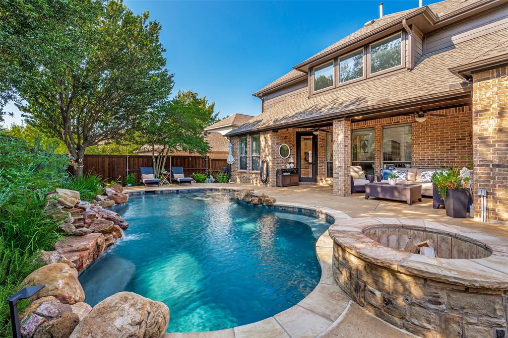 Where meticulous design meets a backyard built for year-round living, this Stonebridge Ranch home commands attention. Solid hand-scraped hardwood floors run throughout the main living areas, grounding the first level in warmth and character. Walls of windows frame the backyard. Outside, a pool, putting green, fire pit, and extended covered patio on a quarter-acre lot creates the perfect private retreat for relaxing and entertaining. Upon entry, a two-story foyer sets a welcoming tone. A private home office sits just off the entry. The kitchen showcases JennAir stainless cooktop, including a new built in double oven, a gas cooktop, a large island with seating, updated lighting, and granite counters, all opening to a breakfast area with direct views of the pool. The open flow between the kitchen, breakfast area, and family room makes hosting effortless. A full wall of windows across the family room floods the layout with natural light and connects to the outdoor living space beyond. The primary suite sits on the first floor with backyard views, dual vanities, a walk-in shower, a jetted tub, and a walk-in closet. Upstairs, three generous bedrooms share the floor with a dedicated media room with surround sound, plus a bright, flexible game room complete with pool table. Rounding out the home, a three-car garage with built-in workbench, a storage shed, a large driveway, and a neighborhood park just a few doors down. Stonebridge Ranch amenities include pools, pickleball and tennis courts, over 20 miles of trails connecting parks and seven stocked fishing lakes. The private Clubs of Stonebridge Ranch nearby offer two championship golf courses, a fitness center, additional tennis and pickleball courts, a family pool, and an adults-only pool. Adriatica Village with waterfront dining, a chapel, and boutique shopping, all within minutes. Downtown McKinney just a short drive with restaurants and shops conveniently located nearby. Quality, comfort, lifestyle is all right here!