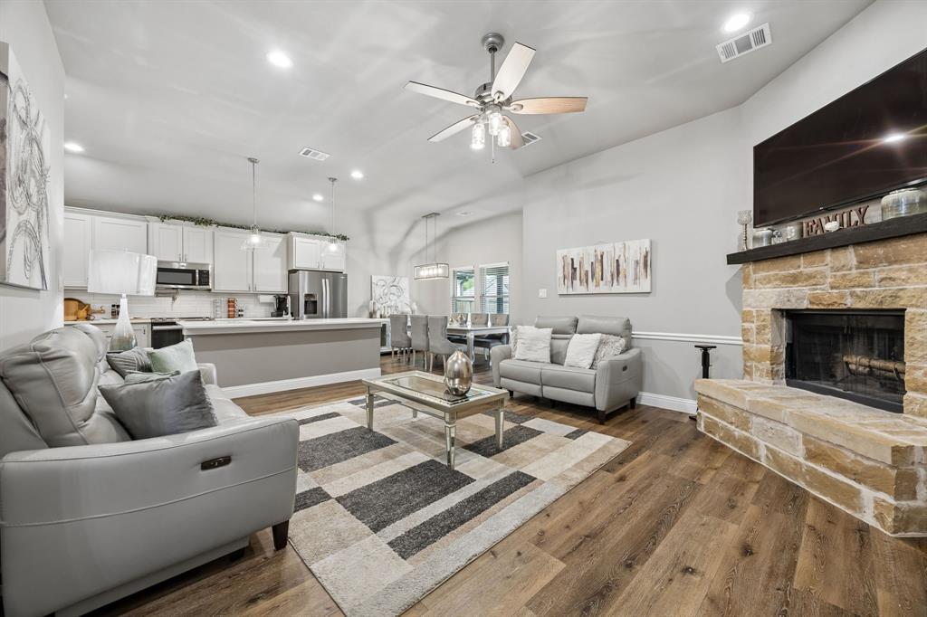 Like-new 3-2 in Mustang Creek, built in 2021 and packed with upgrades that feel custom without the custom price tag. Open-concept layout with wood floors, designer lighting, and a cozy fireplace sets a luxe vibe the moment you walk in. The kitchen is a showpiece, granite counters, oversized island, farmhouse sink, pot filler, pantry, and stainless steel appliances.

The spa-style primary suite brings hotel energy home with dual sinks, soaking tub, frameless glass shower, and a true walk-in closet, plus two flexible bedrooms for office, gym, or guests. Outside, a covered patio and generous backyard are ready for pets, play, and weekend hangouts—minutes from Downtown Pilot Point, local dining, markets, and major routes.
Information is deemed reliable but not guaranteed. Buyers & Buyers Agent to verify all information including but not limited to room size, schools, all MLS data.