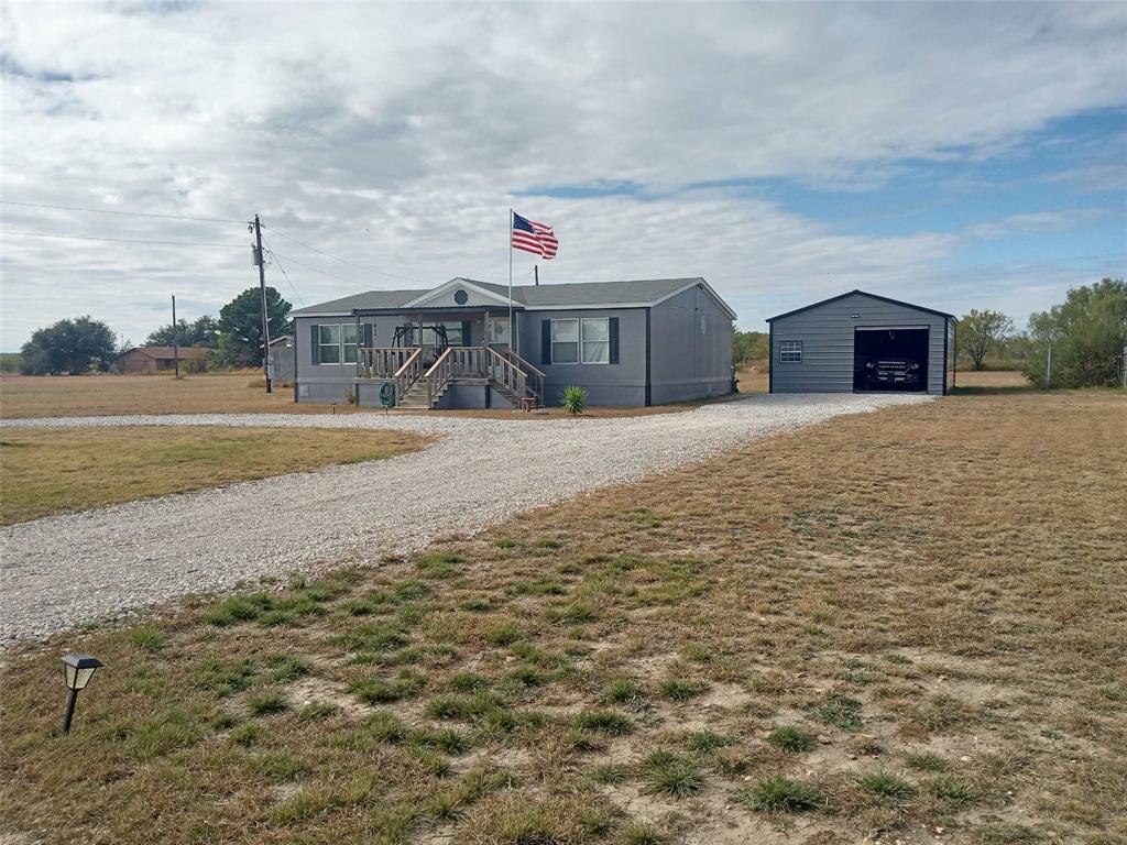 Enjoy country living that is close to town. 3 Bedroom 2 Bath Double Wide that sets on .688 Acres with plenty of room for a garden. Located less than an hour away from five different lakes and less than an hour’s drive from Abilene. The Home has central heat and air with new compressor. New paint inside and out. All new flooring with several new appliances. The home has open concepts with lots of cabinets. It has a covered front and back porch on a quiet street with a new circle driveway and a twenty by Thirty garage that could be used as a shop. This is a must see.