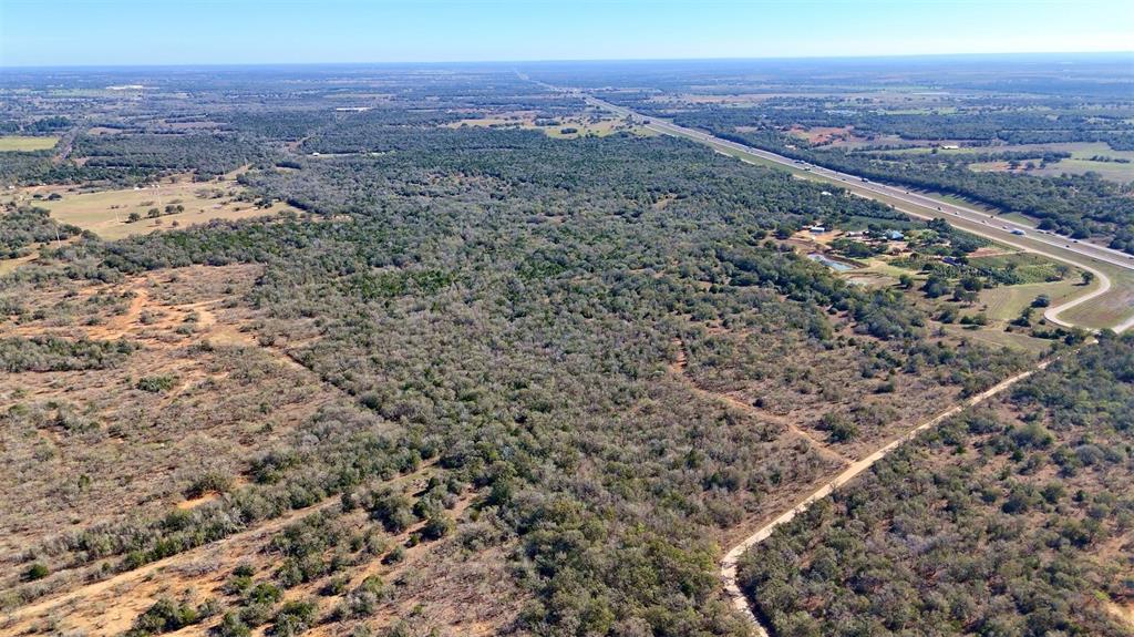 Staples Sotheby's International Realty is honored to present this expansive land offering on behalf of the Aurelia Mitchell Estate. Positioned near Austin, San Antonio, and Houston, this 284 plus acre tract delivers the scale, access, and opportunity you're looking for. With direct access along IH10 and County Road 283 in Harwood, this property offers rare connectivity for large-format development, agricultural expansion, or recreational uses. Current Ag exemption in place. This land features a classic southern post oak savannah feel—broad, open grassy areas mixed with mottes of post oak, live oak, and blackjack with yaupon holly and cedar understory. Improvements include fencing and cross fencing, several seasonal tanks as well as a portion of the property being improved pasture. Ranchers, hunters, and developers alike will appreciate the lands utility with its sandy loam soil, gently rolling topography, and multiple points of access. Bordered by IH10 to the south and CR 283 to the west, this property offers a strategic position for investment or future development. If a larger tract better aligns with your needs and goals, Tract 2 being 384 plus acres to the north is also available, as is the entire 668 plus acres. Large acreage of this quality and accessibility rarely hits the market. Call today to schedule a private tour.