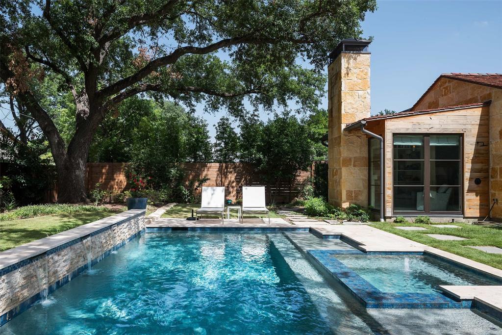 Custom built Modern Mediterranean home designed by award winning architect Bentley Tibbs.The nearly half acre lot with 6763 ft home has dramatic entry with barrel vaulted Venetian plastered ceiling flanked by a library and generous sized living-dining area. The kitchen with an oversized island joins another living area and bright room for an office. A stunning glass stairway leads up to 2 bedrooms and baths and a living area. The primary suite down has sitting area with FP overlooking the pool, a generous sized bath and very large closet. 4 living areas, 4-car garage, 3 fireplaces, wine room, wet bar, covered outdoor living with grilling station, pool and jacuzzi. Steel doors and windows throughout. The stone exterior and flat red tile roof give this modernhome a comfortable feel. Other features include reclaimed wood beams, limestone floors, wide plank hardwoods, open feel throughout and stackable steel doors bringing the outdoors in for entertaining. This house is stunning!