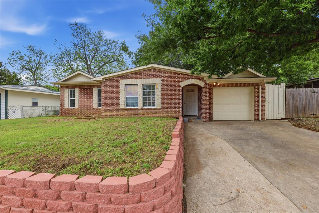 **1 percent buyer credit from lender at closing if buyer uses preferred lender** Well-maintained beauty in the heart of Arlington! So close to education and entertainment hubs of UTA, AT&T Stadium, and Globe Life Field. The brick and stone front welcomes you into this polished 3 bed, 2 bath home that has been nicely updated and is move-in ready! Two generous living areas and dining area open to a beautiful kitchen with crisp white quartz counters and tiled backsplash. Full size utility room is right off the kitchen and adjacent to the garage entry. Great bedroom sizes, and primary bedroom has an ensuite bath and large walk-in closet! Closets and storage space are ample throughout the entire home. Even the yard will impress as bigger than expected. The covered back patio makes a great place to have coffee and escape the sun. The list of upgraded finishes is extensive: LVP flooring throughout, ceiling fans and lots of recessed lighting, wood burning fireplace, stainless appliances, fully tiled baths with separate toilet areas, one car garage space, stone retaining wall in front yard. This house is terrific - come make it your reality!