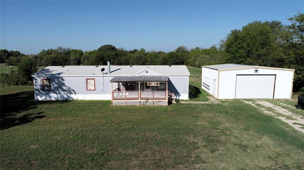 WONDERFUL 3-2 DOUBLEWIDE ON 2.25 ACRES. HAS LARGE DETACHED 2 CAR GARAGE, SHOP WITH ELECTRIC DOOR. HOME HAS OPEN DESIGN, PRETTY KITCHEN, ALSO HAS LARGE OFFICE THAT COULD BE FOURTH BEDROOM. MASTER BATH HAS SEPARATE GARDEN TUB AND SHOWER. LARGE UTILITY ROOM. PROPERTY HAS GATED ENTRY WITH ELECTRIC GATE. HUGE PECAN TREE IN FRONT YARD. THIS IS A GREAT PROPERTY WITH PLENTY OF ROOM FOR EXPANSION, GARDENING, CHICKENS AND MORE.