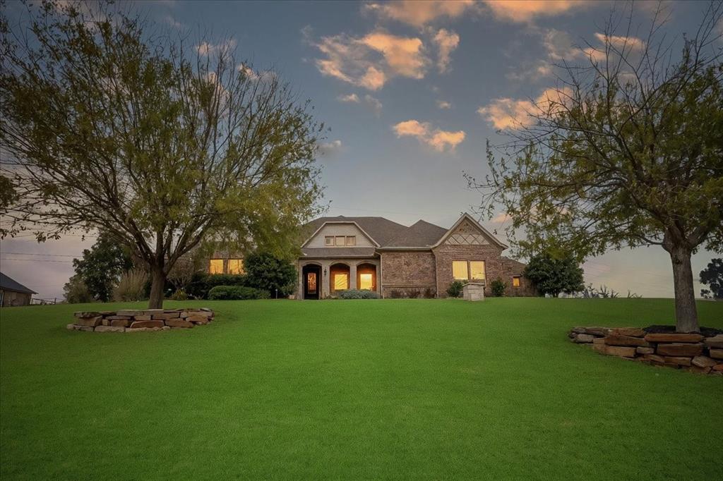 Welcome to this beautiful 4-bedroom home in the highly sought-after, guarded Bella Flora community. Nestled on over an acre with amazing sunset views and spectacular springtime bluebonnets, this property blends privacy, luxury, and everyday comfort—designed with easy entertaining in mind.
Step inside to a spacious living room with warm wood floors, plantation shutters, which are also throughout the home, and a gas fireplace. The open floor plan flows seamlessly into the large kitchen, featuring granite countertops, abundant storage, a butler’s pantry, and a generous breakfast nook. A formal dining room offers the perfect setting for hosting, while a second living area with French Doors provides flexible space ideal for an office, playroom, home gym, or media room.
The retreat-like oversized primary suite is a haven of relaxation with a stunning ensuite bath showcasing dual vanities, a separate shower, and a large walk-in closet. Guests will appreciate the private ensuite bedroom, while two additional bedrooms share a convenient Jack-and-Jill bath.
Step outside to your backyard oasis, complete with a covered patio, outdoor living and dining area with built in grill, and a sparkling pool added in 2022. With thoughtful upgrades throughout, this home offers the perfect blend of elegance and functionality in one of Fort Worth's premier gated communities. Loads of upgrades including: new HVACs in 2024, whole house generator, wood floors in living spaces (no carpet), and many more. See documents for more detail.