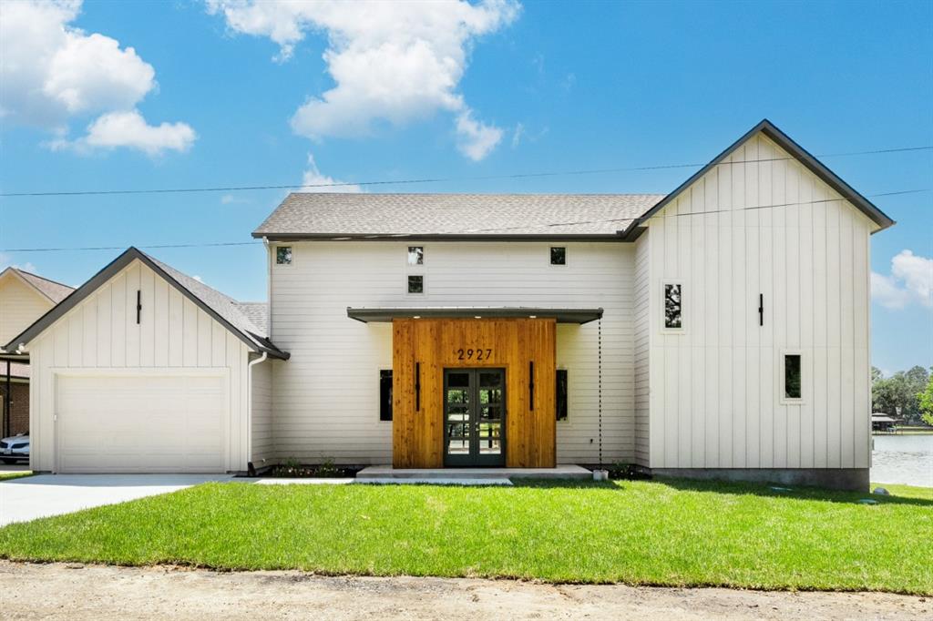 New Build 2026 by Dad & Daughter Custom Homes offers an exquisite and spacious 3363 SQFT of meticulously designed living space on 220-feet of open water frontage with a beach area. This home is ideal for single or multi-generational living, featuring two separate primary suites and two distinct living areas. First floor, a bright open-concept living, dining, and kitchen designed to maximize natural light and showcase panoramic water views, anchored by elevated 10-foot ceilings, 60-inch linear electric fireplace and 16’x8’ slider door creating indoor-outdoor living. The open kitchen features abundant custom cabinetry, elegant Savona Quartz countertops, large center island, Janska Professional 48” 8 Burner Swedish gas range with touchless range vent, premium KitchenAid stainless steel appliances - two dishwashers - microwave - refrigerator, and spacious walk-in pantry. Sizable wet bar with custom cabinets, sink, wine-beverage fridge, ice maker, and glass rinse station nicely positioned aside living room. Half bath, mud room, utility room, and electrical-storage room off living room. The downstairs primary suite serves as a private retreat with serene panoramic waterfront views - lake accessible through 12’ x 8’ slider door; the large primary bathroom offering dual sinks, oversized walk-in shower and tub glass inclosure, and generous walk-in closet. Upstairs, offers a second primary suite showcasing stunning water views and access to 16’x14’ upper balcony, additional family room with 12’x8’ slider door for access to upper balcony, 2 secondary bedrooms (one with ensuite offering water views), two full bathrooms, and storage closet. Outdoor living is equally impressive with a massive covered waterfront patio. Designed for year-round enjoyment, the outdoor living and kitchen area includes built-in 36” propane BBQ grill, sink, trash and storage drawers. Buyer and buyer’s agent to verify all information. A full list of new home amenities are available.