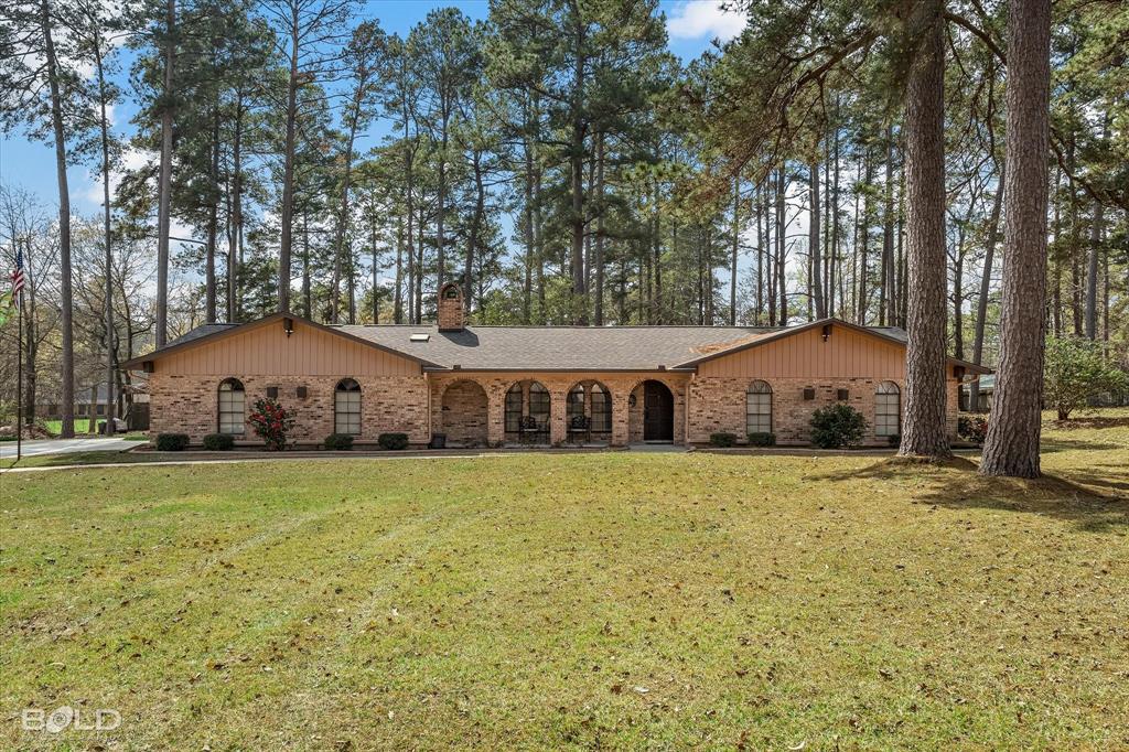 PRICE REDUCED. NO CITY TAXES. Meticulously cared for home on 1.4 plus acres in the Blanchard area. This home has so much to offer. When you step inside you will be greeted by a beautiful hand painted New Orleans style courtyard mural and Italian marble flooring. The living room features a vaulted ceiling with wood beams, gas log fireplace surrounded by Italian marble, gorgeous wood floor and more. A spacious kitchen boasts lots of cabinets, plenty of counterspace, electric cooktop, separate oven, dishwasher with stainless interior, fridge, pantry, breakfast bar and more. This home has a roomy breakfast room with bay windows and a separate formal dining room with chandelier and french doors leading to an open patio. Just past the breakfast room is a den that opens to a large game room or bonus room. This room has a vaulted beam ceiling, gas log fireplace, built-in bookcases, bay windows with seating and storage and entry to a large enclosed screened patio with skylight. Bonus room and patio wired for sound, can be played just inside, outside or simultaneously. A large primary bedroom is appx 19 x 14 features a walk-in closet with cedar wall, ensuite bath with double sinks and more. This room also has french doors facing the back yard and a private patio.  Both guest bedrooms are roomy with cedar lined closet. The hall bath features a large counter top and skylight for lots of natural light. Just off the kitchen is a big laundry room with half bath and skylight. Both fireplaces can be converted back to wood burning. A big shady back yard features 2 storage buildings and lots of beautiful flowers. The perimeter of the home is landscaped. Paved driveway with lots of extra parking space. New roof in 2025 and newer gutters with leaf guards. Flag pole in front yard remains. 10 minutes or less from shopping, dining, schools and more. This home has so much to offer that it is a MUST SEE to appreciate. HOA covers entrances, neighborhood phone book